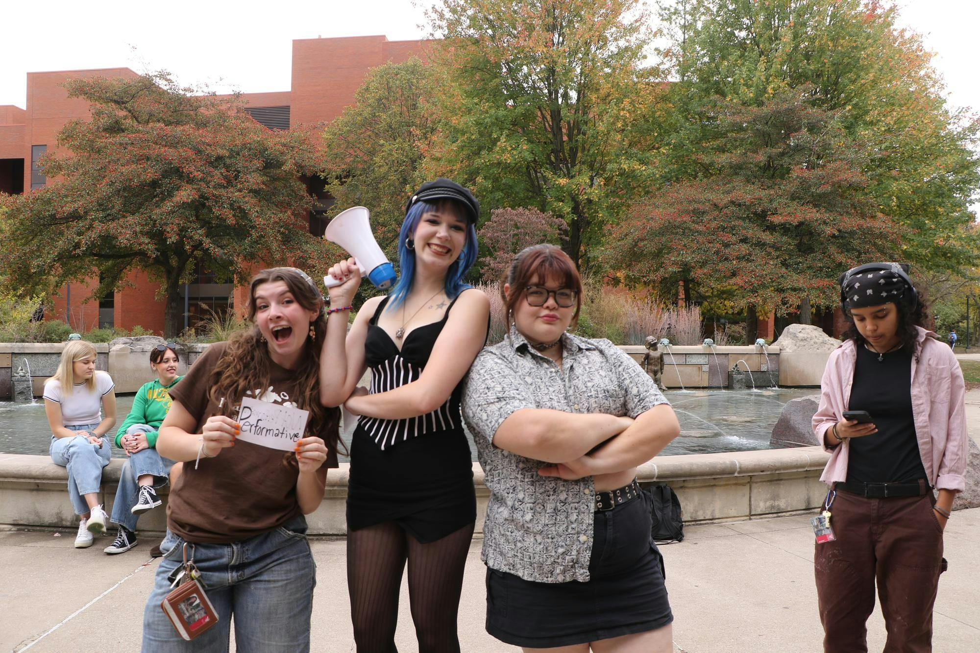 Ball State students and organizers of the event Evie Robertson, Madison Cole and Natalie Stover pose for a picture Oct. 17 by Frog Baby Fountain. Gracie Parkhurst, DN