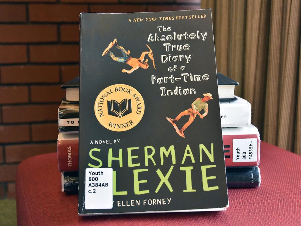 "The Absolutely True Diary of a Part-Time Indian" written by Sherman Alexie leaning against a stack of other banned books on Sept.29 in Bracken Library. The book is a first-person perspective on life on a Spokane Indian Reservation. Ella Howell, DN