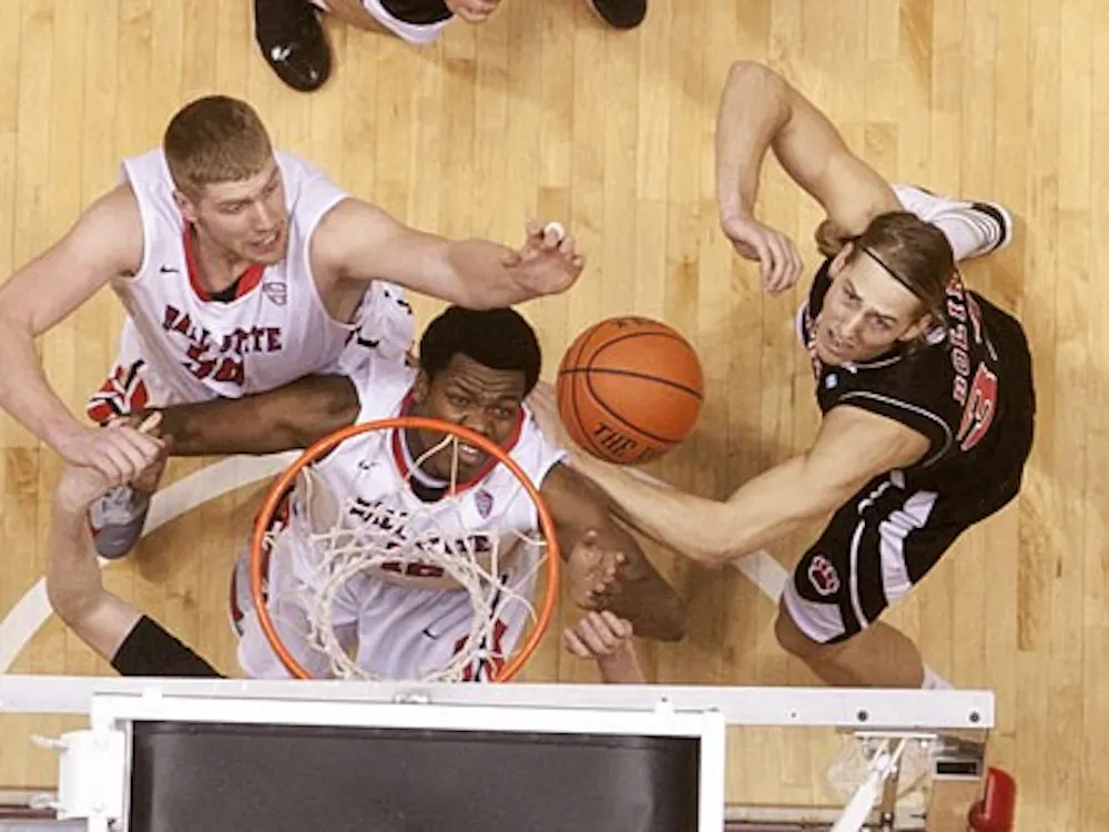 Zach Fields and Bo Calhoun from Ball State fight for the redound against Northern Illinois's Aksel Bolin to catch the rebound. Ball State won the game 53 to 51. DN PHOTO JORDAN HUFFER