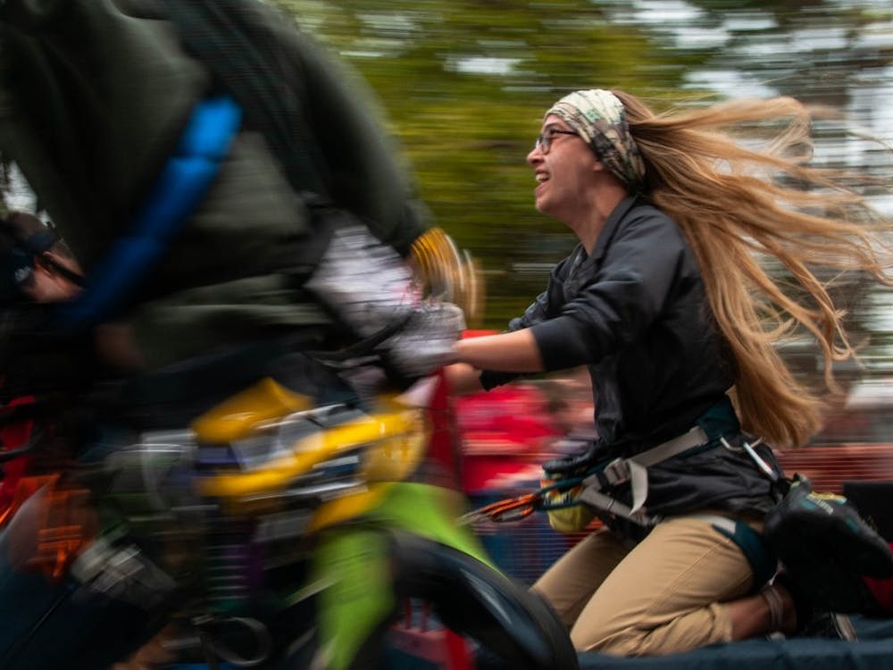 Members of Ball State's Climb Club compete in Bed Races Oct. 19, 2018, on Riverside Ave. The entire block of Riverside is shut down during this hour every Homecoming weekend. Madeline Grosh,DN