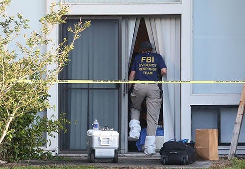 FBI evidence response team enters an apartment Wednesday, May 22, 2013 in Orlando, Florida, after an FBI agent shot and killed a man who was questioned in connection with the Boston Marathon bombings. MCT PHOTO