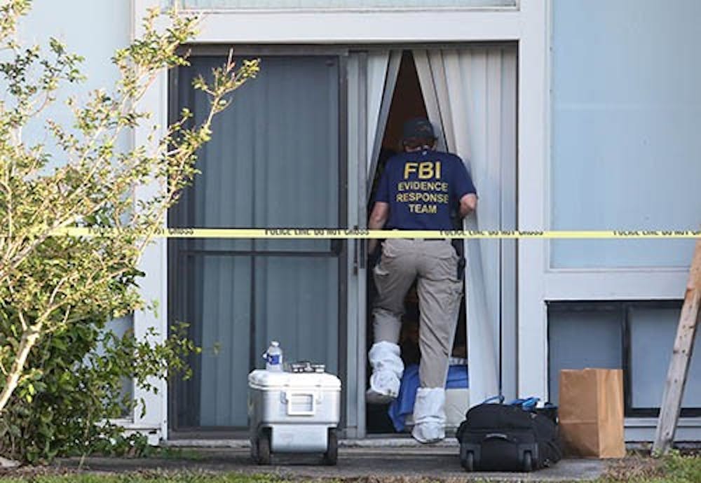 FBI evidence response team enters an apartment Wednesday, May 22, 2013 in Orlando, Florida, after an FBI agent shot and killed a man who was questioned in connection with the Boston Marathon bombings. MCT PHOTO