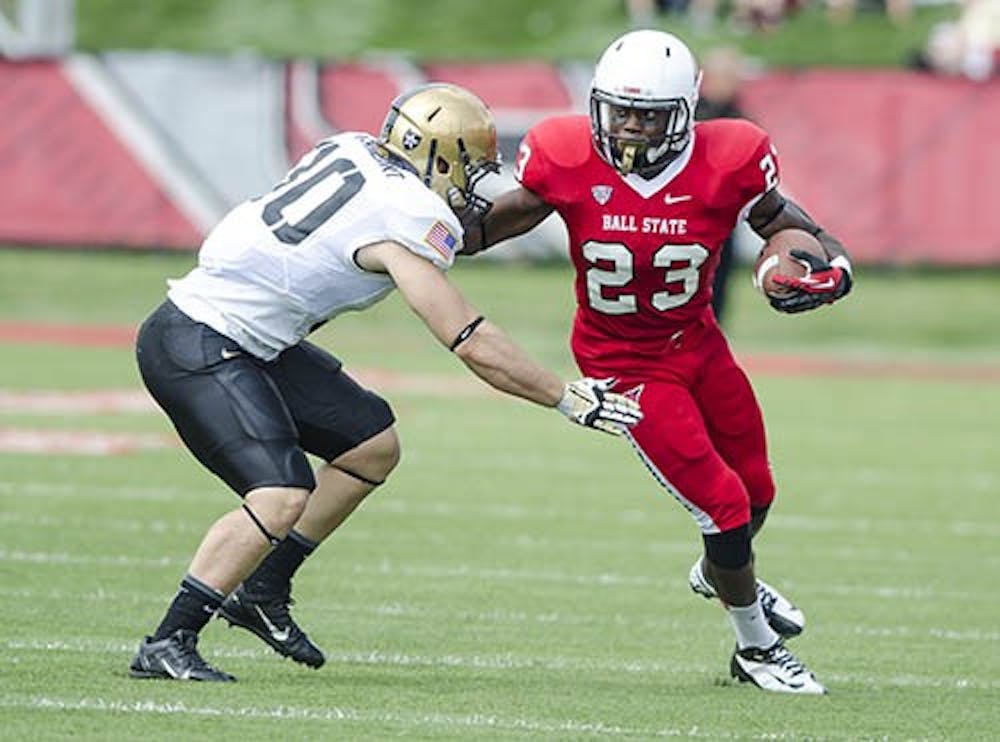 Ball State running back Teddy Williamson attempts to juke an army defender during a drive on Sept. 7. Williamson had 58 yards rushing during the game today. DN PHOTO COREY OHLENKAMP