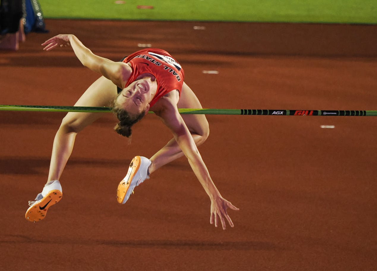 Senior Charity Griffith clears the ﻿bar during an attempt in the high jump at the NCAA Outdoor Track &amp; Field Championships. Griffith would go on to win the event and be crowned the national champion. Brendan Maloney, photo courtesy