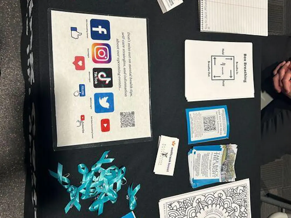 The Ball State Counseling Center table in the Jo Ann Gora Student Recreation and Wellness Center during the “What Were You Wearing” event on Wednesday, April 17. Victims of sexual assault are often asked what they were wearing which is a form of victim blaming. (Maya Kim, DN)