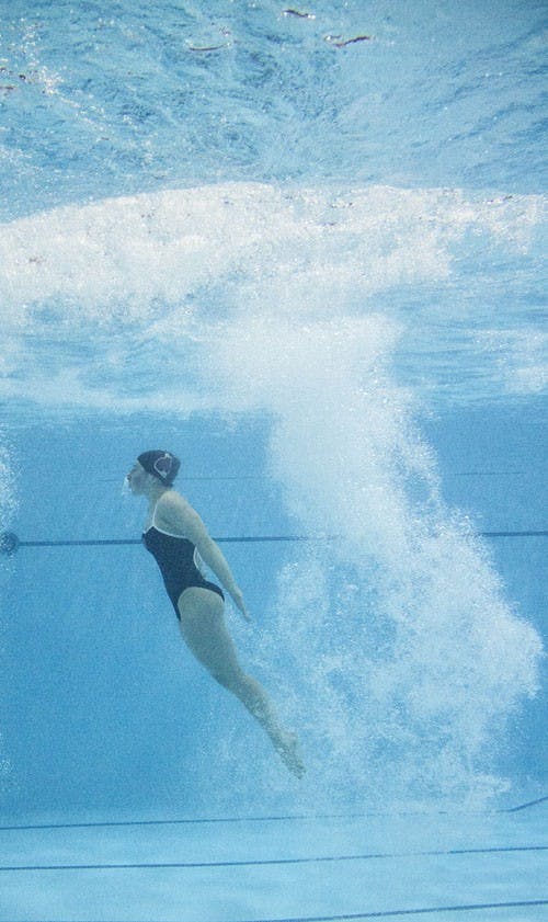 A diver competes Jan. 25 in Lewellen's Aquatic Center. Women's swim and dive won 135-105. DN PHOTO EMMA FLYNN