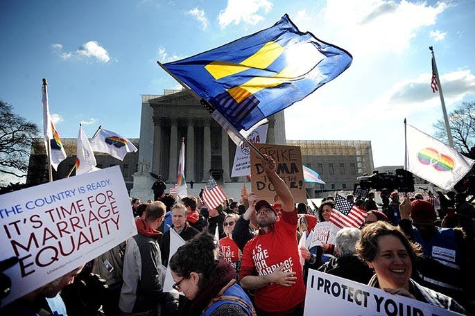 Demonstrators gather in front of the U.S. Supreme Court on Wednesday, March 27, 2013, as the court hers argments on a part of the 1996 Defense of Marriage Act that prevents legally wed same-sex couples from receiving certain benefits by defining marriage as between a man and woman. (Olivier Douliery/Abaca Press/MCT)