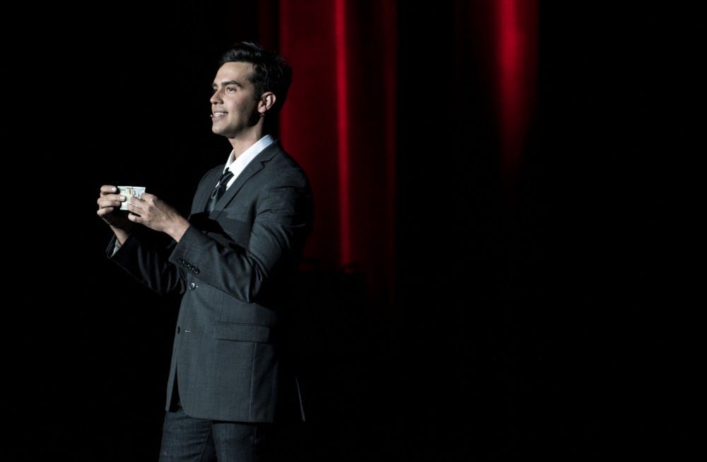 Michael Carbonaro performs at John R. Emens Auditorium on Sept. 16 for his magic act called " The Carbonaro Effect." Carbonaro shows everyone the $100 bill that he grabbed from an audience and does his first act. Stephanie Amador // DN