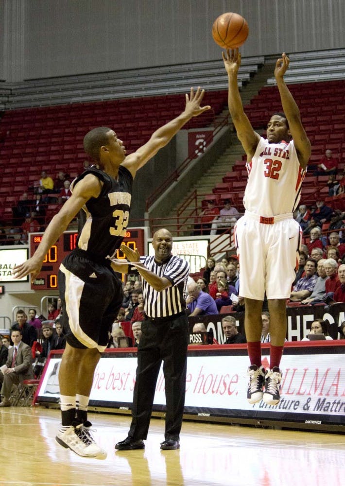 Junior guard Jesse Berry attempts a jump shot as Wofford’s Spencer Collins tries to make a block on the play Friday. Tonight, the Cardinals will host in-state rival Indiana State at 7 p.m. at home. DN FILE PHOTO TAYLOR IRBY