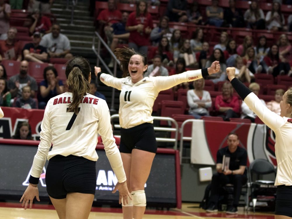 Natalie Risi (7), Amber Seaman (11), and Maggie Huber (6) celebrate winning their second match against Austin Peay on September 20, 2019, at Worthen Arena. Ball State continued on to win 3-0. Jaden Whiteman, DN