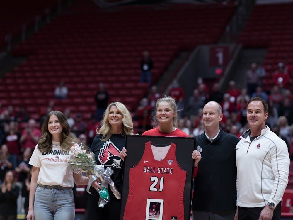 Senior Blake Smith poses for a photo with her family and Ball State women's basketball Head Coach Brady Sallee before their game against Eastern Michigan University Mar. 5 at Worthen Arena. The Cardinals celebrated their senior Mar. 4 by presenting Smith, their only senior, with a framed jersey. Eli Houser, DN