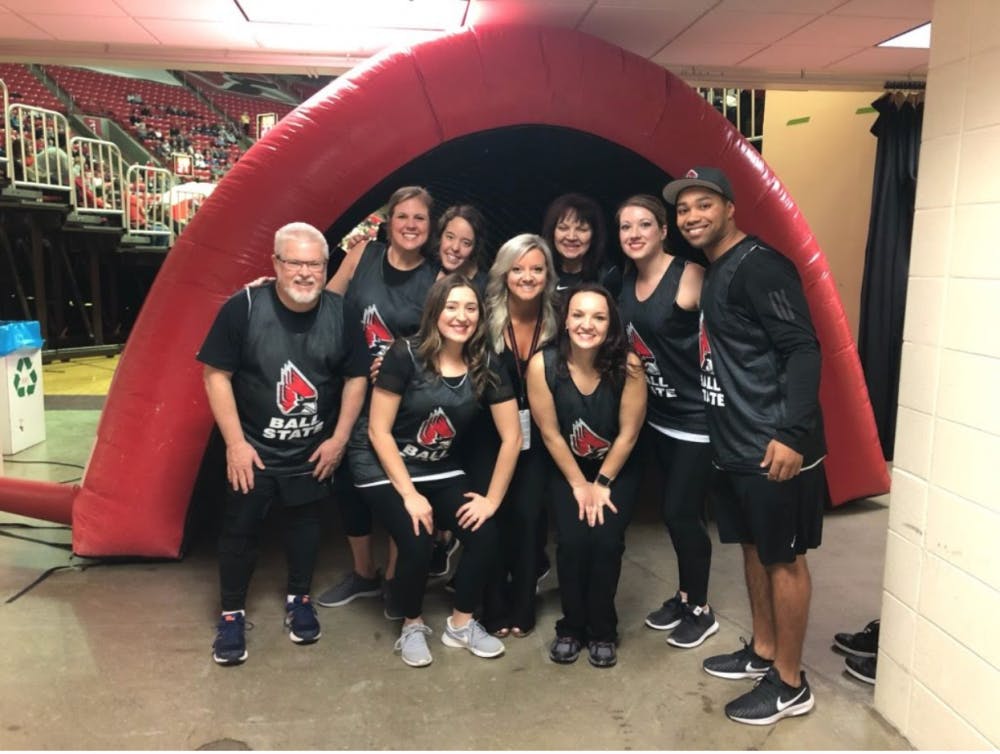 The Ballers, faculty and staff dance team, pose before taking the floor during a men's basketball game on Feb. 9. The team is made up of Mike Gillilan, Jessica Allardt, Michelle Jones, Candace Olszak, Larissa Wright, Blake Beemer Stormie Kirby and Renee Haack. Olivia McGarvey, Photo Provided