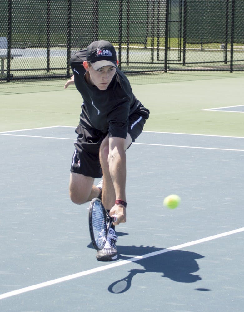 Senior Ray Leonard hits the ball during the match against Western Michigan on April 11 at Cardinal Creek Tennis Courts. DN PHOTO ALAINA JAYE HALSEY
