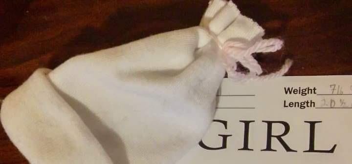 A baby hat sits on top of a birth certificate in 2009. Greyhawks daughter was born on October 31. Courtney Greyhawk, Photo Provided
