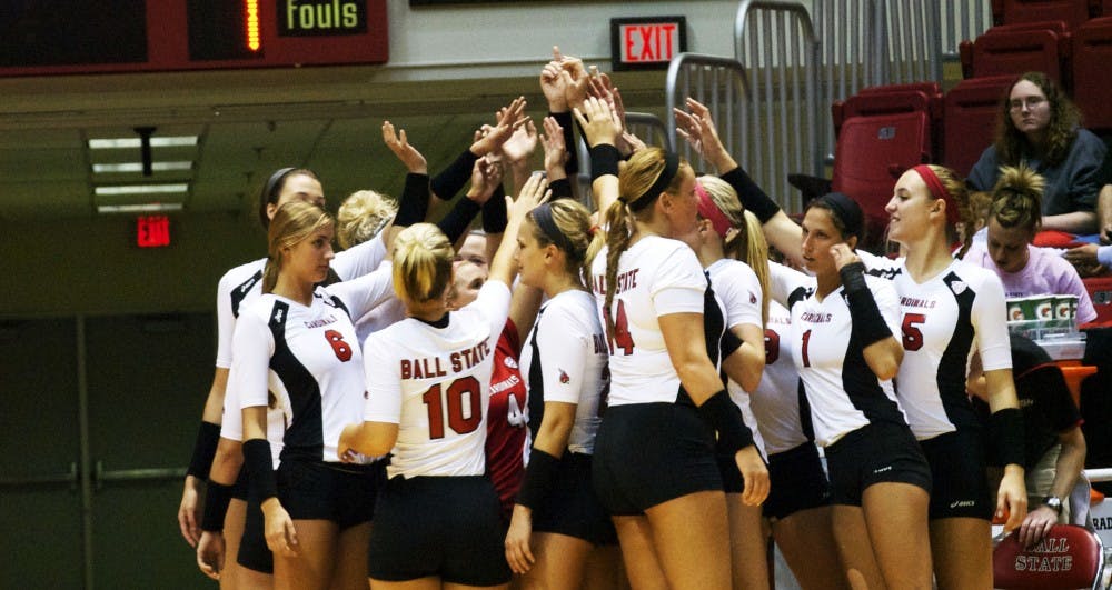 The volleyball team huddles together before returning to play the third set of the game Oct. 3 against Eastern Michigan.  DN PHOTO SAMANTHA BRAMMER