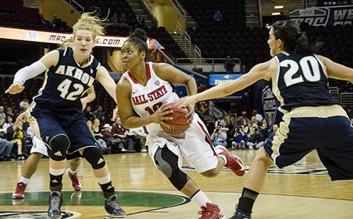 Shanee' Jackson drives directly into the Akron defense hoping to get close enough to score a two point basket. DN PHOTO COREY OHLENKAMP