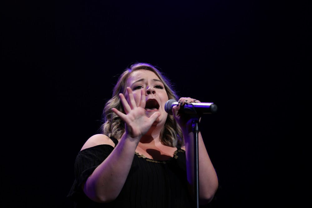 <p>Paige Matteson sings "Gravity" by Sara Bareilles during the 33rd annual Talent Search in John R. Emens Auditorium on Tuesday, Oct. 17, 2017. Matteson won the female vocal and overall categories and received $1,000 in scholarship money. <strong>Mary Freda, DN</strong></p>