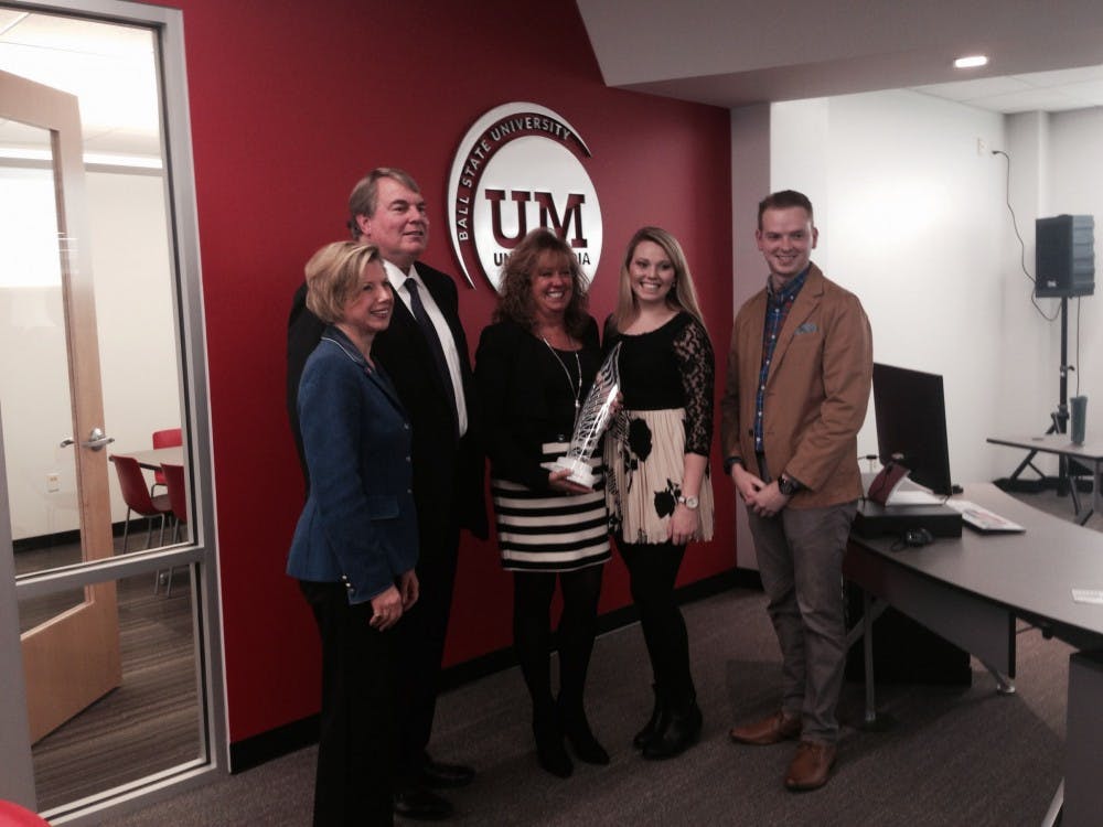 President Jo Ann Gora poses with alumnus and Ball State University Foundation Director Mark Holden and his family. Holden donated a significant portion of the funding required to build the Unified Media lab. DN PHOTO EMMA KATE FITTES