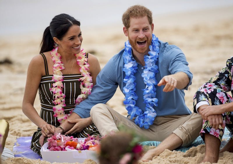 FILE - In this Friday, Oct. 19, 2018 file photo Britain's Prince Harry and Meghan, Duchess of Sussex meet with a local surfing community group, known as OneWave, raising awareness for mental health and wellbeing in a fun and engaging way at Bondi Beach in Sydney, Australia. Buckingham Palace said Monday May 6, 2019, that Prince Harry's wife Meghan has gone into labor with their first child.(Dominic Lipinski/Pool via AP, File)