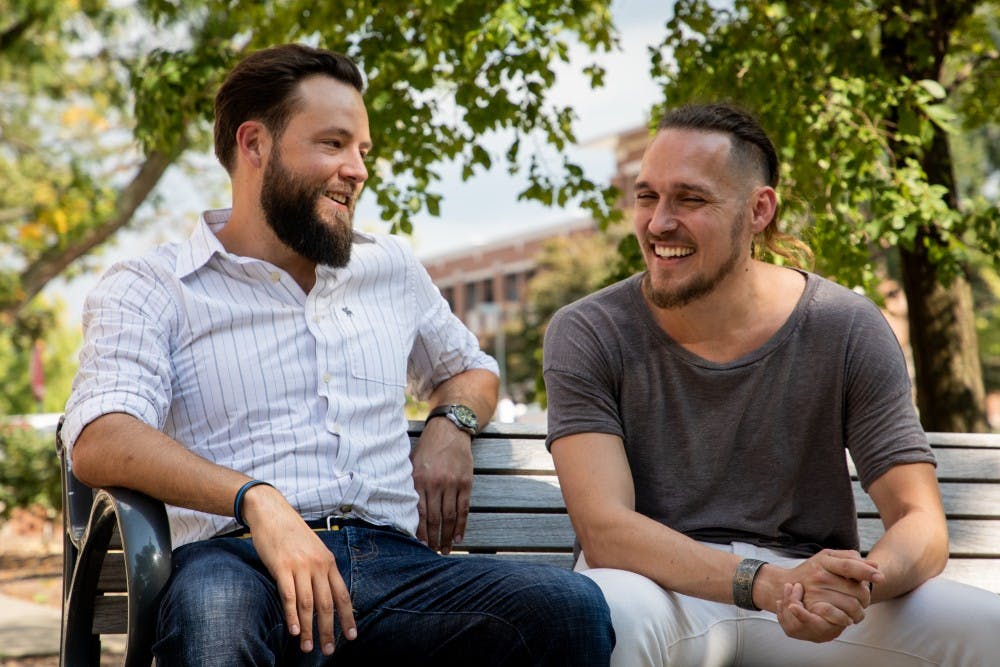 Josh Vandiver and Henry Velandia laugh during an interview in the Quad Sept. 13, 2019. The couple battled laws that would have deported Venezuelan Velandia even though he was married to Vandiver, who is a U.S. citizen. Eric Pritchett, DN