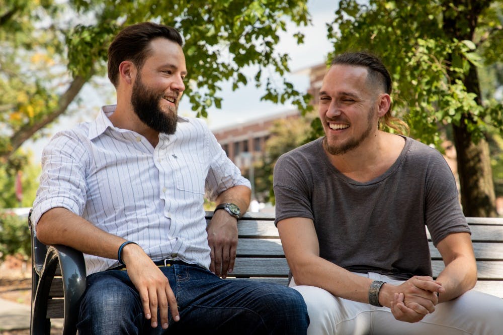 <p>Josh Vandiver and Henry Velandia laugh during an interview in the Quad Sept. 13, 2019. The couple battled laws that would have deported Venezuelan Velandia even though he was married to Vandiver, who is a U.S. citizen. <strong>Eric Pritchett, DN</strong></p>