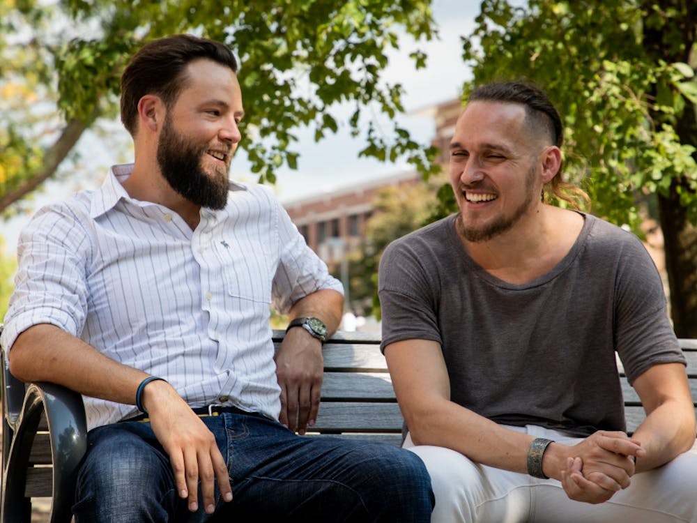Josh Vandiver and Henry Velandia laugh during an interview in the Quad Sept. 13, 2019. The couple battled laws that would have deported Venezuelan Velandia even though he was married to Vandiver, who is a U.S. citizen. Eric Pritchett, DN