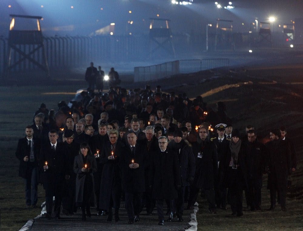 <p>Diginitaries arrive to put candles at a memorial site Jan. 27, 2020, at the Auschwitz Nazi death camp in Oswiecim, Poland. Survivors of the Auschwitz-Birkenau death camp gathered for commemorations marking the 75th anniversary of the Soviet army's liberation of the camp, using the testimony of survivors to warn about the signs of rising anti-Semitism and hatred in the world today. <strong>(AP Photo/Czarek Sokolowski)</strong></p>