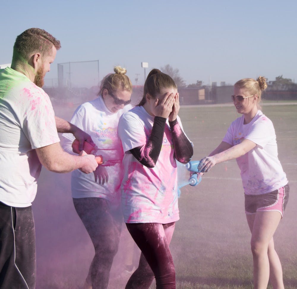 People participated in the 4th annual Chase the Rainbow 5K on April 16 at Bethel Field. Participants were colored with wet and dry paint throughout the course. DN PHOTO CURTIS SILVEY