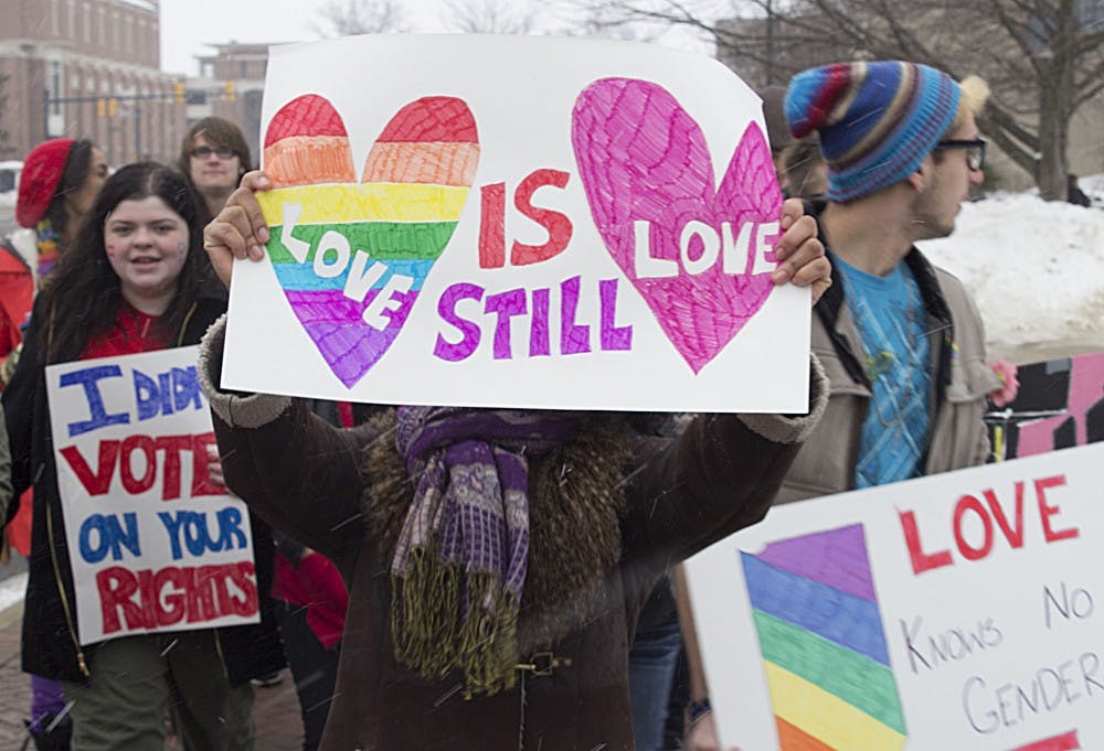 A student holds a sign reading "love is still love" during a protest on Feb. 14. The protest sought to bring attention to the issue of marriage equality. DN PHOTO ANDREW KELLY