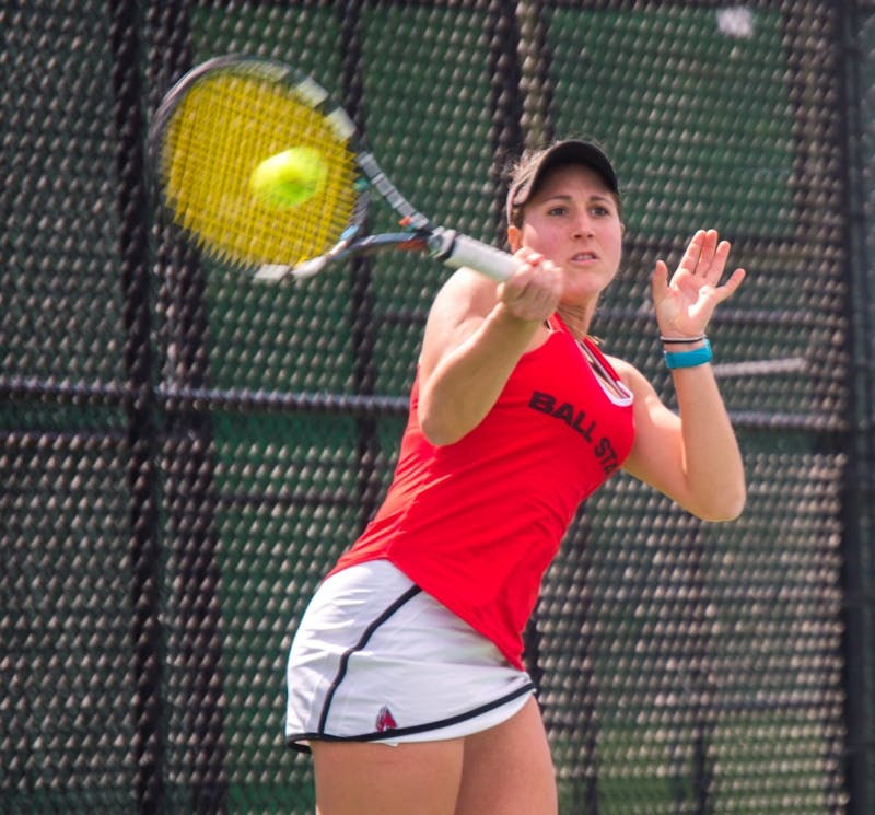 Senior Carmen Blanco hits the ball during the match against Buffalo on April 2 at the Cardinal Creek Tennis Center. Blanco won her match 2-0. Teri Lightning Jr., DN