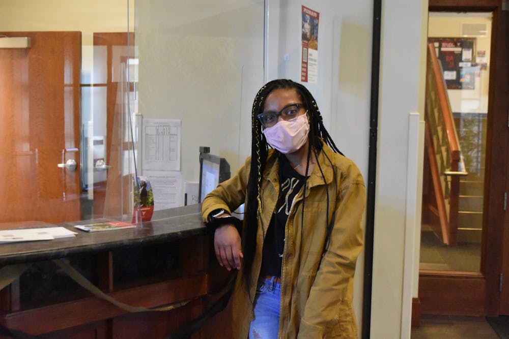 Junior psychology major Nykasia Williams stands by the front desk in Park Hall where she has worked as a desk staff member for two years. Williams helps Park Hall residences with any issue they have from lost keys to checking out equipment. Grace Duerksen, DN