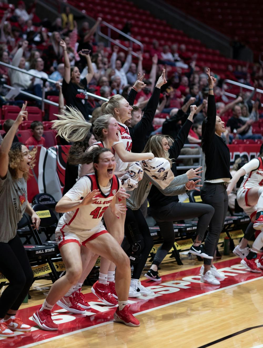 Members of the Ball State Women's Basketball team celebrate after senior Blake Smith hits a three-pointer in their game against Eastern Michigan University Mar. 5 at Worthen Arena. The Cardinals rotated their entire bench into the line up on Senior Night. Eli Houser, DN