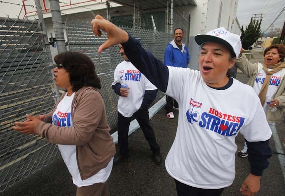 Elvira Delgado gives a thumbs down as she leads her fellow striking bakery workers on the picket line at the Hostess Bakery on Friday in Los Angeles. The judge hearing the case has ordered Hostess and its second largest union must sit down for mediation, halting the liquidation of the company and its assets. MCT PHOTO