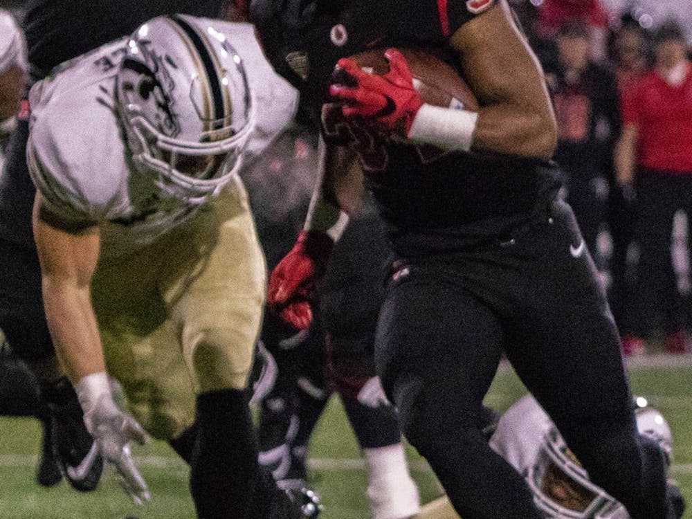 Ball State redshirt junior running back James Gilbert breaks away from Western Michigan defenders late in the second quarter Tuesday, Nov. 13 at Scheumann Stadium. The Cardinals won the game, 42-41 in overtime. Sharpe L. Marshall,DN