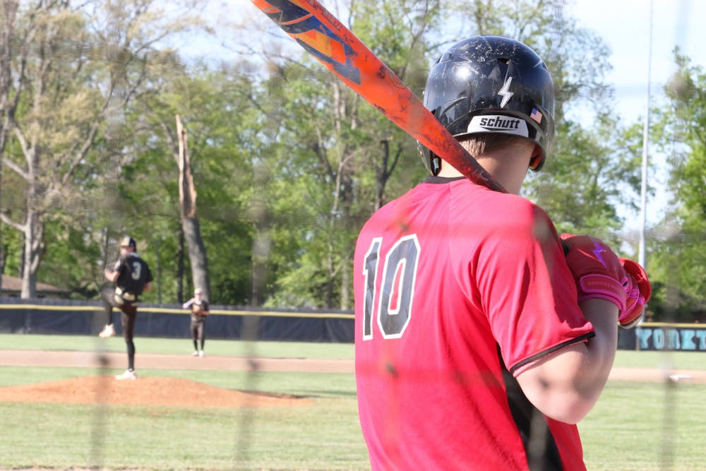 Wapahani senior Daxton Dudley watches Daleville starting pitcher junior Meryck Adams from the on-deck circle during first round of Delaware County Tournament at Yorktown High School. Zach Carter, DN