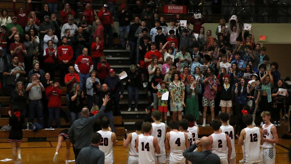 Wapahani boys' basketball waives and claps with the crowd March 1 after defeating Wes-Del in the sectional No. 40 semi-final round at Alexandria-Monroe High School. Zach Carter, DN. 
