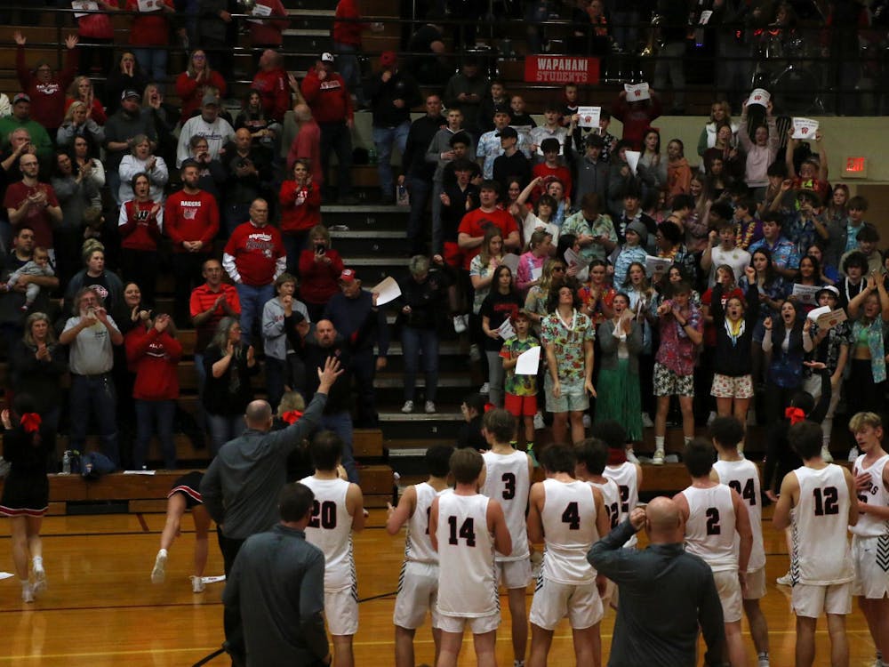 Wapahani boys' basketball waives and claps with the crowd March 1 after defeating Wes-Del in the sectional No. 40 semi-final round at Alexandria-Monroe High School. Zach Carter, DN. 