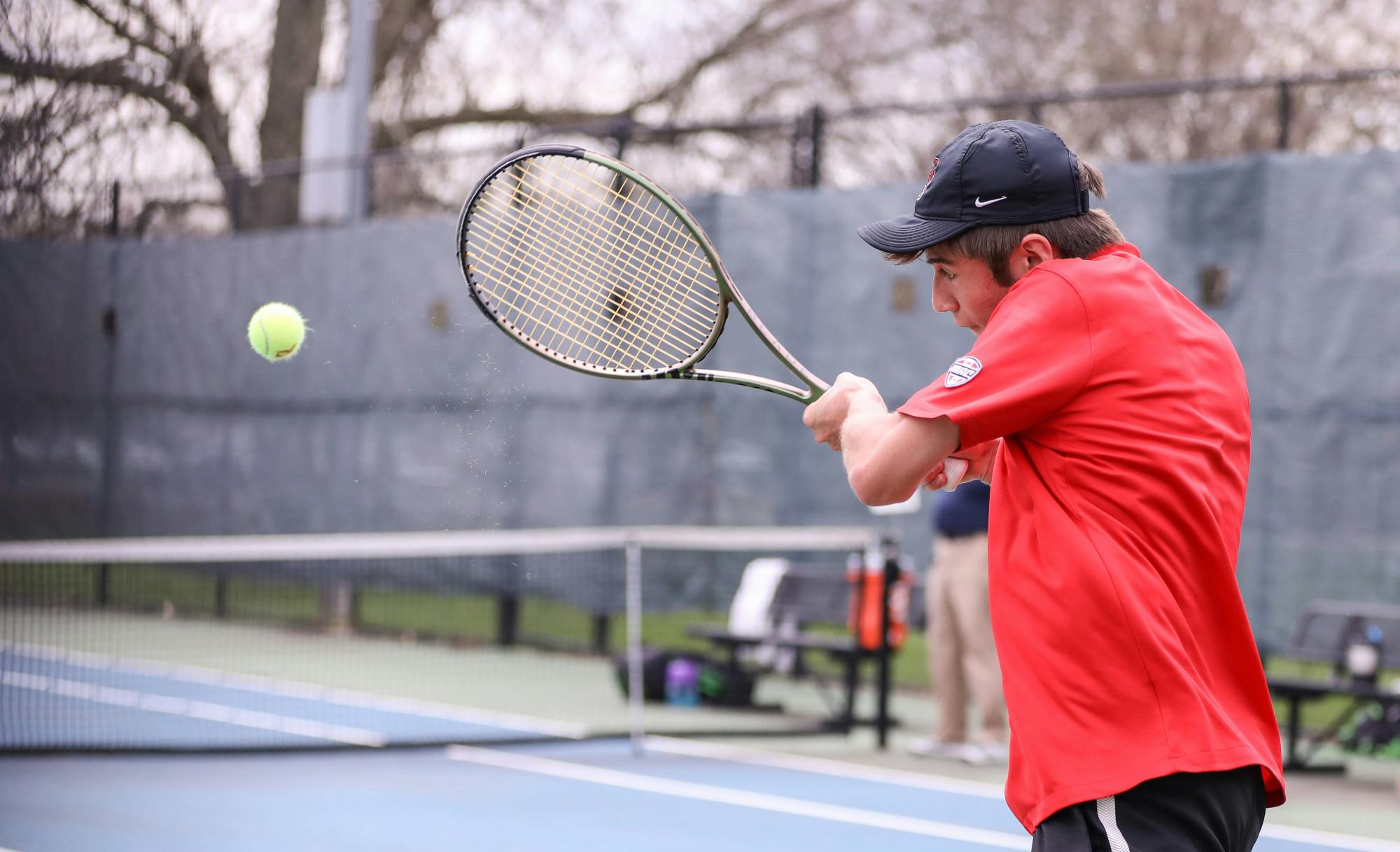 First-year Broc Fletcher hits the ball back to opponent in a match against Binghamton University on April 14 at the Cardinal Creek Tennis Center. Katelyn Howell, DN. 