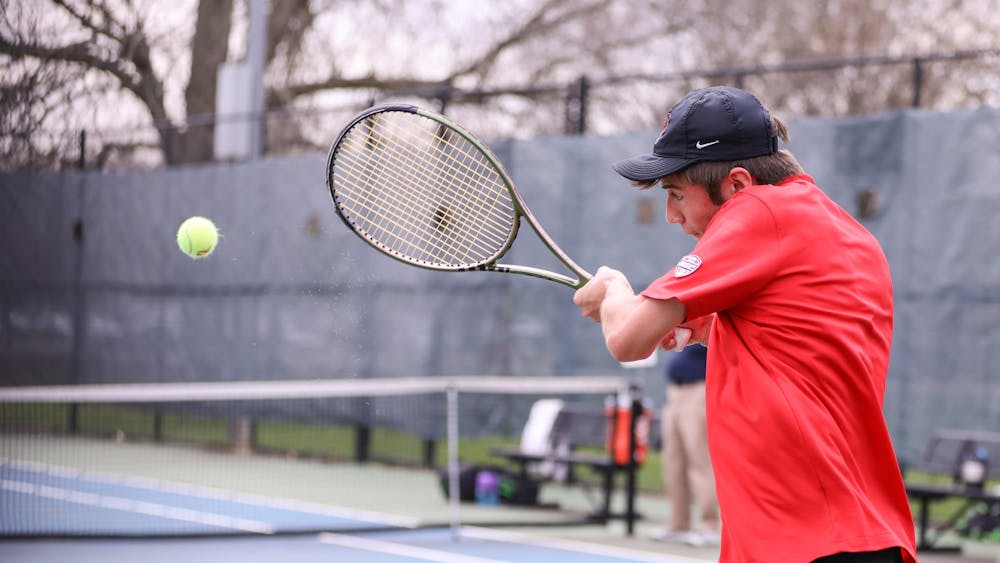 First-year Broc Fletcher hits the ball back to opponent in a match against Binghamton University on April 14 at the Cardinal Creek Tennis Center. Katelyn Howell, DN. 