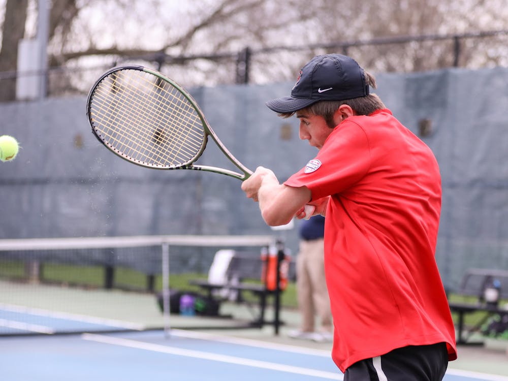 First-year Broc Fletcher hits the ball back to opponent in a match against Binghamton University on April 14 at the Cardinal Creek Tennis Center. Katelyn Howell, DN. 