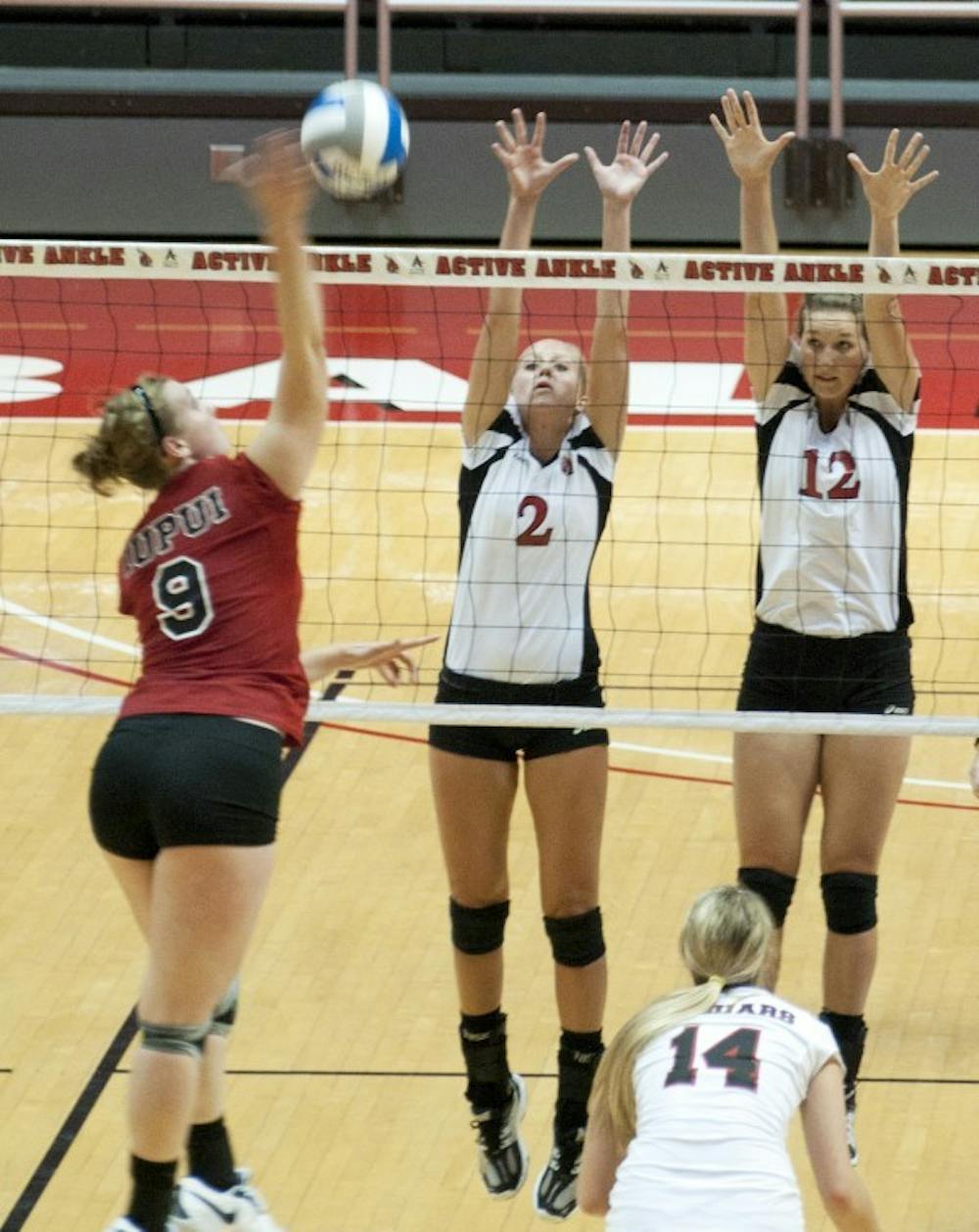 Brittany McGinnis and Jennifer Boyd attempt to block a spike by an IUPUI hitter earlier this season. Ball State defeated Appalachian State 3-2 at Chapel Hill, NC Saturday. DN FILE PHOTO BOBBY ELLIS