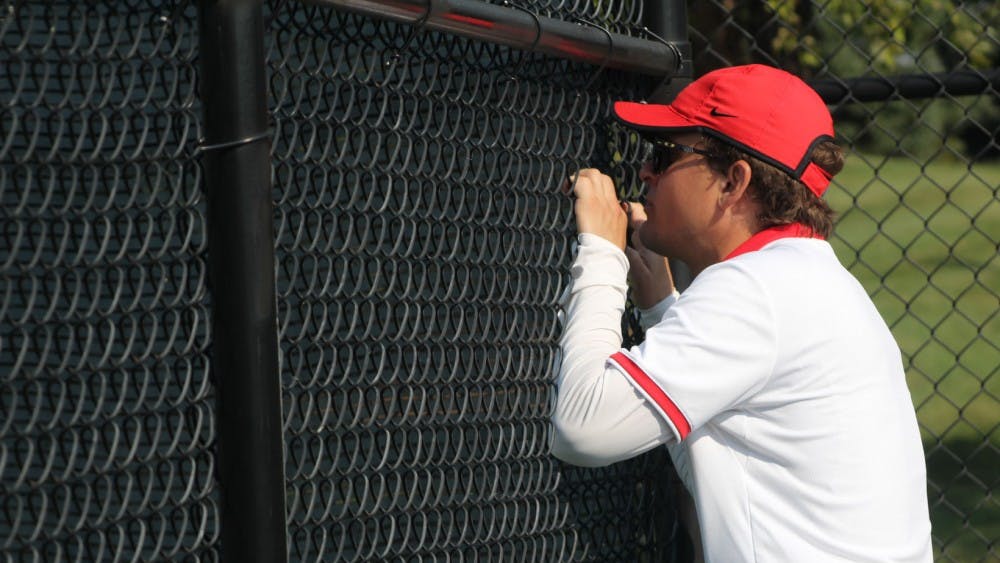 Women's tennis head coach Max Norris talks to senior Sarah Swiderski in her first round singles match against Detroit Mercy. Norris enters his sixth season as head coach of Ball State. Photo by Patrick Murphy