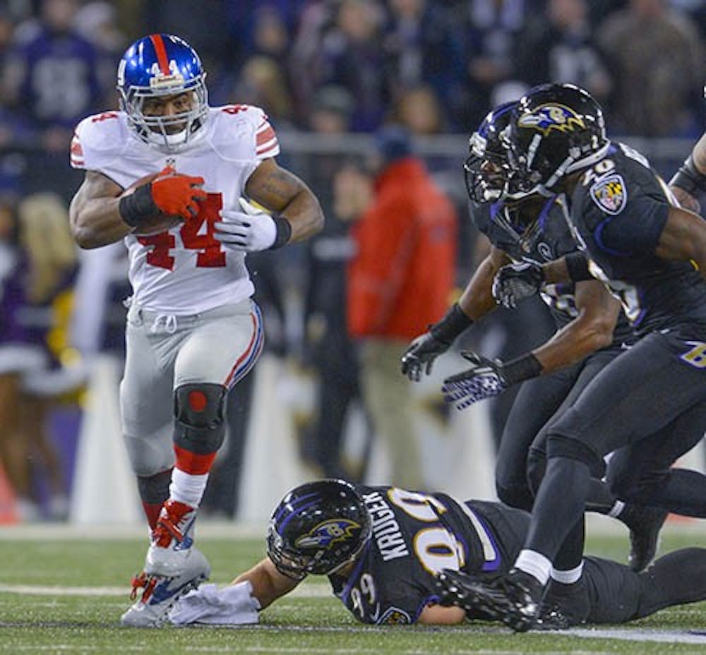 Ahmad Bradshaw breaks the tackle attempt of diving Baltimore Ravens outside linebacker Paul Kruger on December 23, 2012, in Baltimore. Bradshaw signed with the Colts this week and will be part of their 2013-14 line up. MCT PHOTO