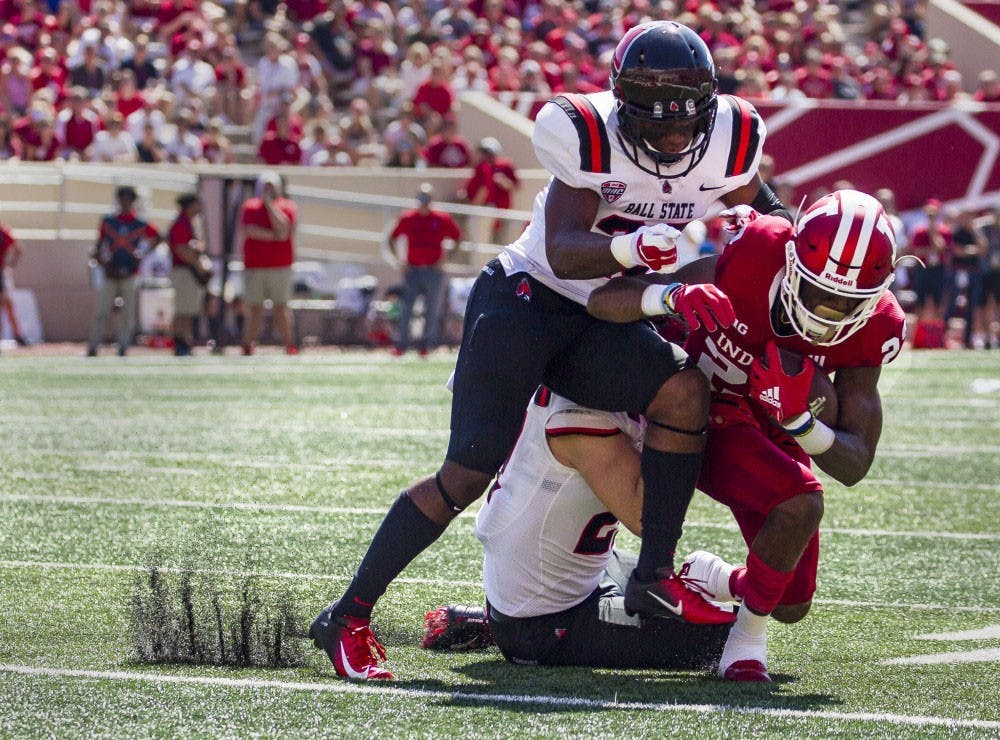Sophomore wide receiver Whop Philter is tackled by junior safety Brett Anderson II and offensive linebacker Jimmy Daw, Sept. 15, 2018, at Memorial Stadium in Bloomington, Ind. Ball State lost to IU 10-38, making this their second loss of the season. Grace Hollars, DN