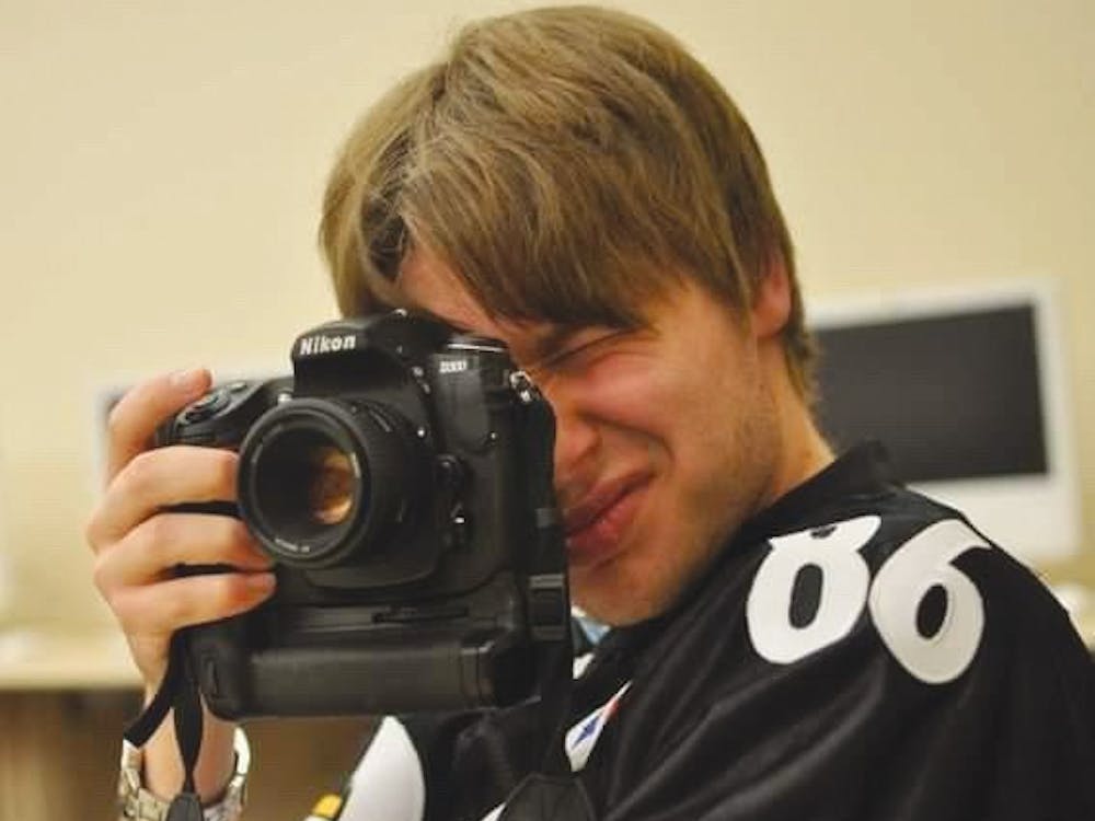 Ball State Creative Strategist Bobby Ellis uses his camera while he worked at the Daily News in 2010. Bobby Ellis, Photo Provided