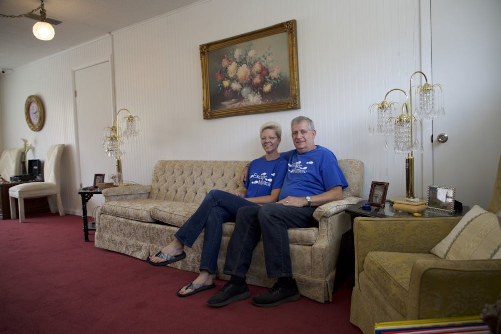 Jennifer and Bruce Everetts sit in the lobby of The Adventures of Gilbert and Maude — Escape Muncie&#x27;s newest location — Aug. 23, 2021. The lobby features 1920s-themed decor to set the scene for the escape rooms. Grace McCormick, DN