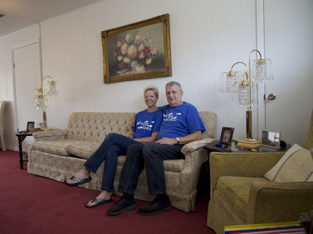 Jennifer and Bruce Everetts sit in the lobby of The Adventures of Gilbert and Maude — Escape Muncie's newest location — Aug. 23, 2021. The lobby features 1920s-themed decor to set the scene for the escape rooms. Grace McCormick, DN