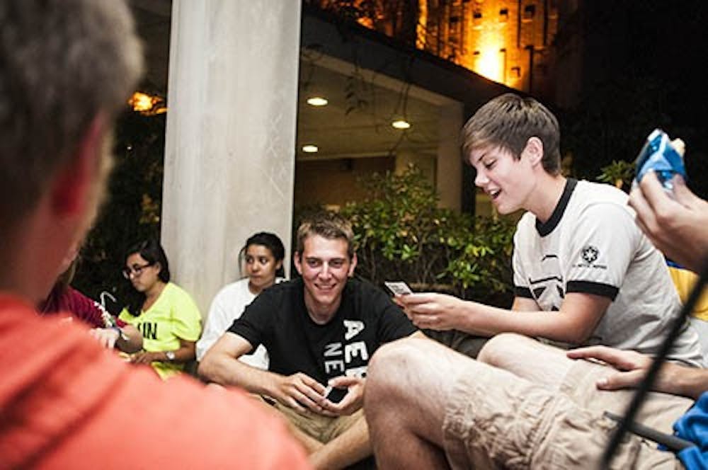 Students play Cards Against Humanity as they wait for Jason Mraz tickets. The Emens Box Office opens Sep. 6 at 8 a.m. DN PHOTO JONATHAN MIKSANEK