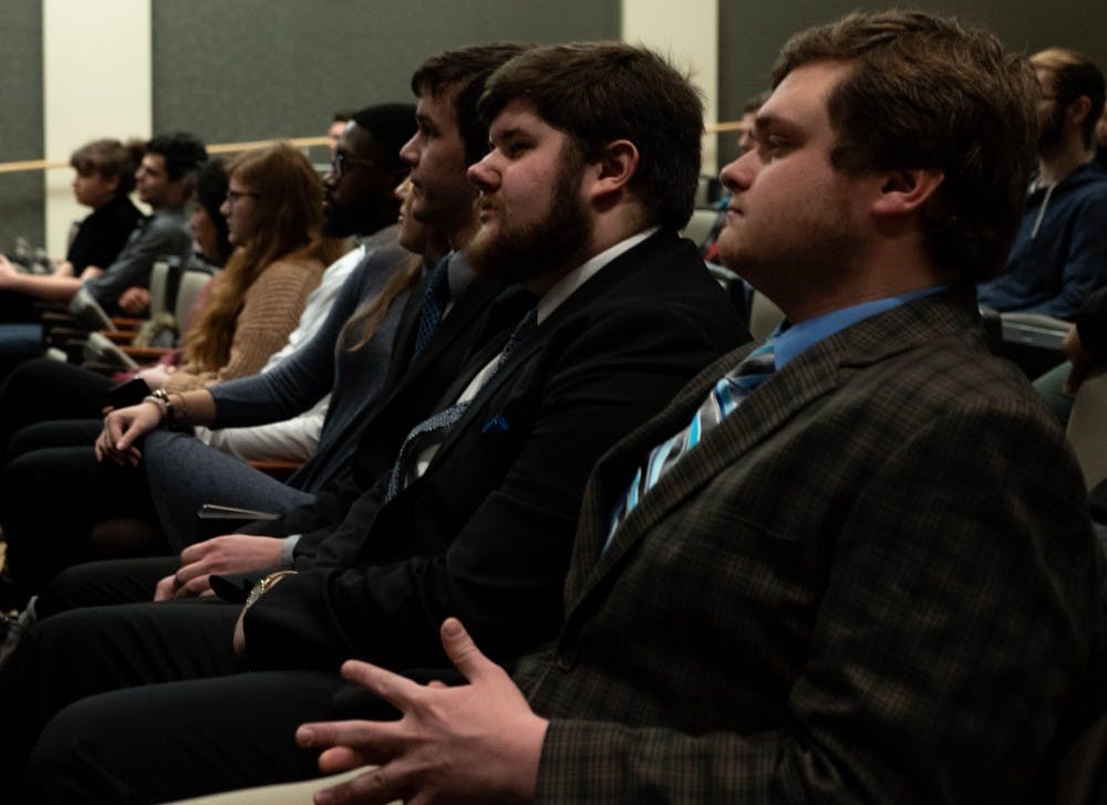<p>Jake Biller, presidential candidate for the United slate, and Andy Hoffman, campaign manager for the United slate, listen to a speaker Feb. 12, 2019 during the Student Government Association nomination convention in the Arts and Journalism building. <strong>Scott Fleener, DN</strong>&nbsp;</p>