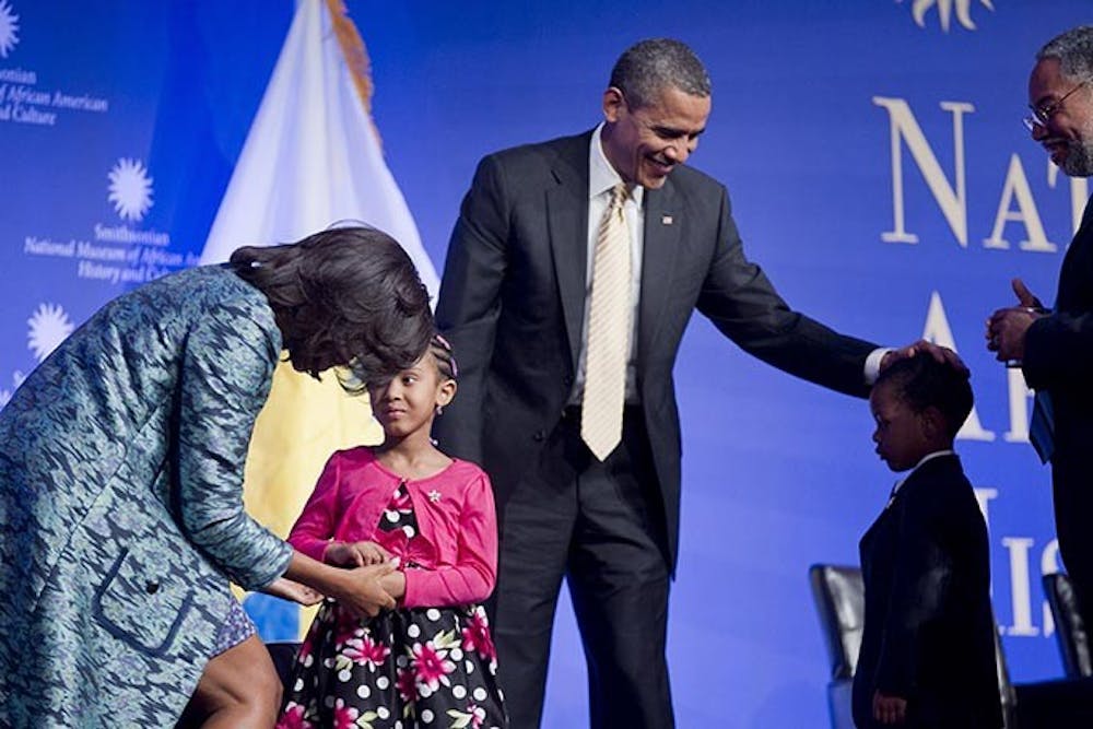 President Barack Obama and first lady Michelle Obama, left, greet children from a local Montessori school at the groundbreaking ceremony of the Smithsonian National Museum of African American History and Culture with Lonnie Bunch, director of the museum, far right, in Washington, D.C., February 22, 2012. (Andrew Harrer/Abaca Press/MCT)